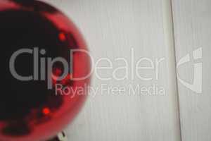 Red christmas bauble on wooden table