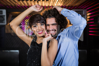 Cute couple dancing together on dance floor