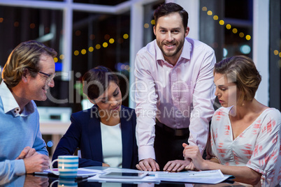 Businesspeople discussing on documents in office