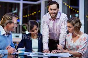 Businesspeople discussing on documents in office