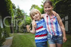 Portrait of kids standing with arms crossed in park