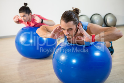 Men exercising on exercise ball