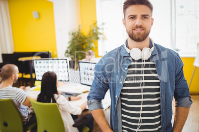 Portrait of confident executive standing at creative office