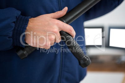 Security officer holding a baton