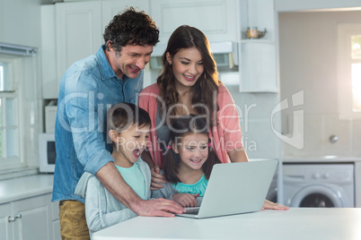 Happy family using laptop