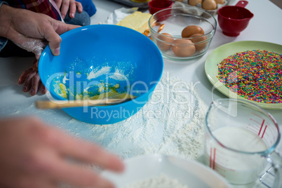 Close-up of man preparing cupcake