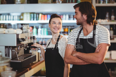 Waiter and waitress smiling at each other