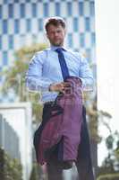 Portrait of handsome businessman holding blazer