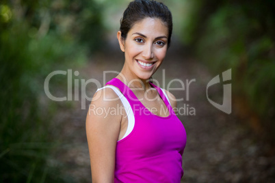 Woman jogging through a forest