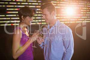 Couple toasting glass of champagne in bar