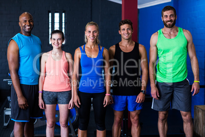 Cheerful friends standing in gym