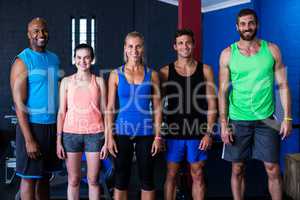 Cheerful friends standing in gym