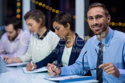 Businesspeople preparing document in office