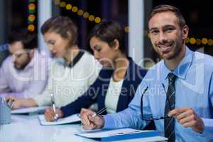 Businesspeople preparing document in office