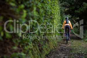 Female biker cycling in countryside