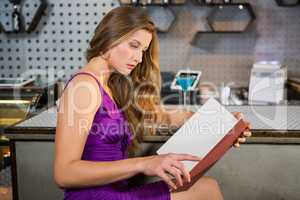 Beautiful woman reading the menu
