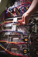 Technician plugging patch cable in a rack mounted server