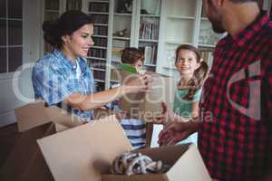 Family unpacking cartons together