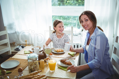 Mother and daughter having breakfast