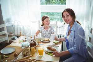 Mother and daughter having breakfast