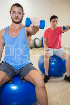 Men exercising on exercise ball