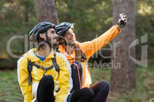 Biker couple taking selfie from mobile phone