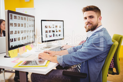 Portrait of confident editor working in creative office