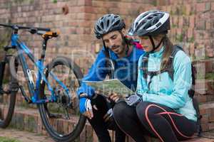 Biker couple looking at a map