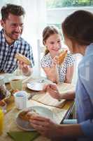 Happy family having breakfast