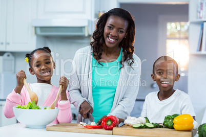 Portrait of mother with their children preparing food