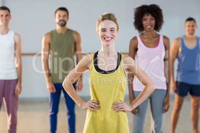 Instructor and students standing in fitness studio