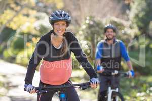 Biker couple cycling in countryside