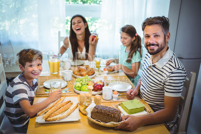 Happy family having breakfast together