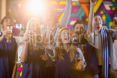 Group of friends cheering in party while having glass of champagne