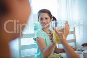 Smiling girl toasting her juice glass