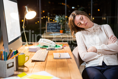 Tired businesswoman sleeping on chair