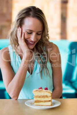 Smiling woman looking at pastries on plate