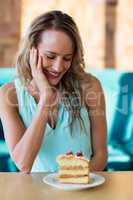 Smiling woman looking at pastries on plate