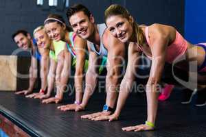 Male and female athletes doing push-ups