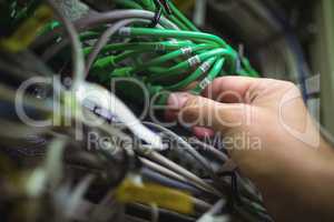 Technician plugging patch cable in a rack mounted server