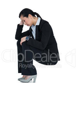 Depressed businesswoman sitting on steps