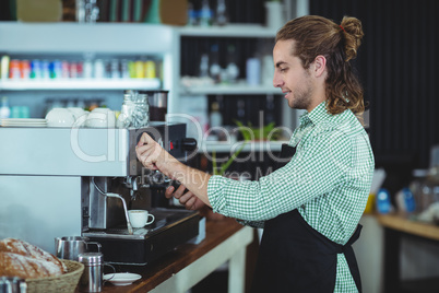 Waiter making cup of coffee