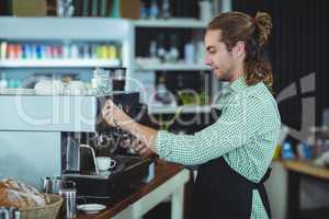 Waiter making cup of coffee