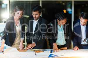 Group of businesspeople discussing over document