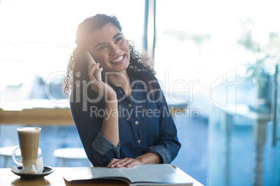 Smiling woman talking on mobile phone