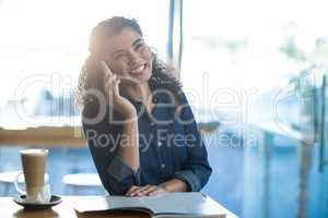 Smiling woman talking on mobile phone