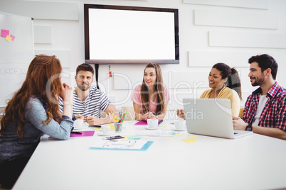 Happy executives during meeting in creative office