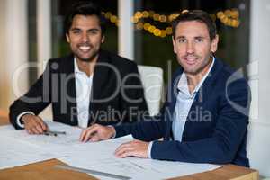 Businessmen sitting at their desk in the office