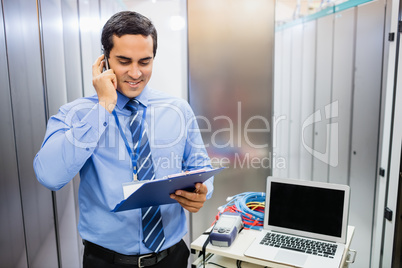 Technician talking on mobile phone