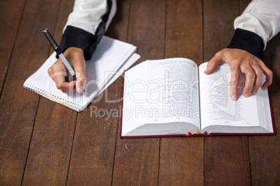 Woman with a bible writing on notepad